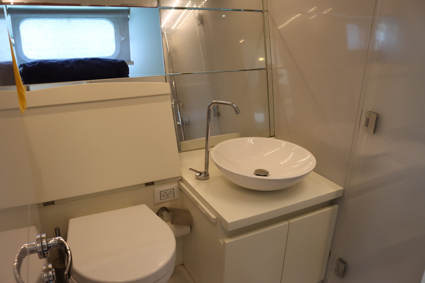 Guest head with vessel sink and electric toilet