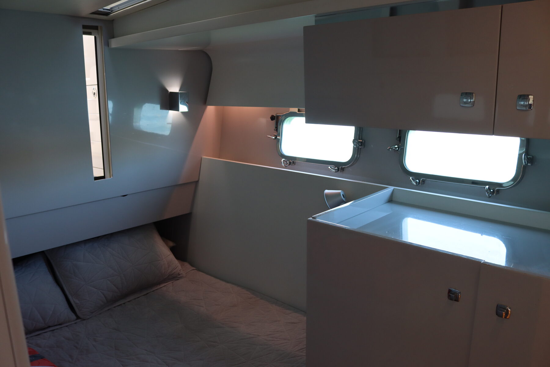 Guest stateroom with side berth and twin portlights